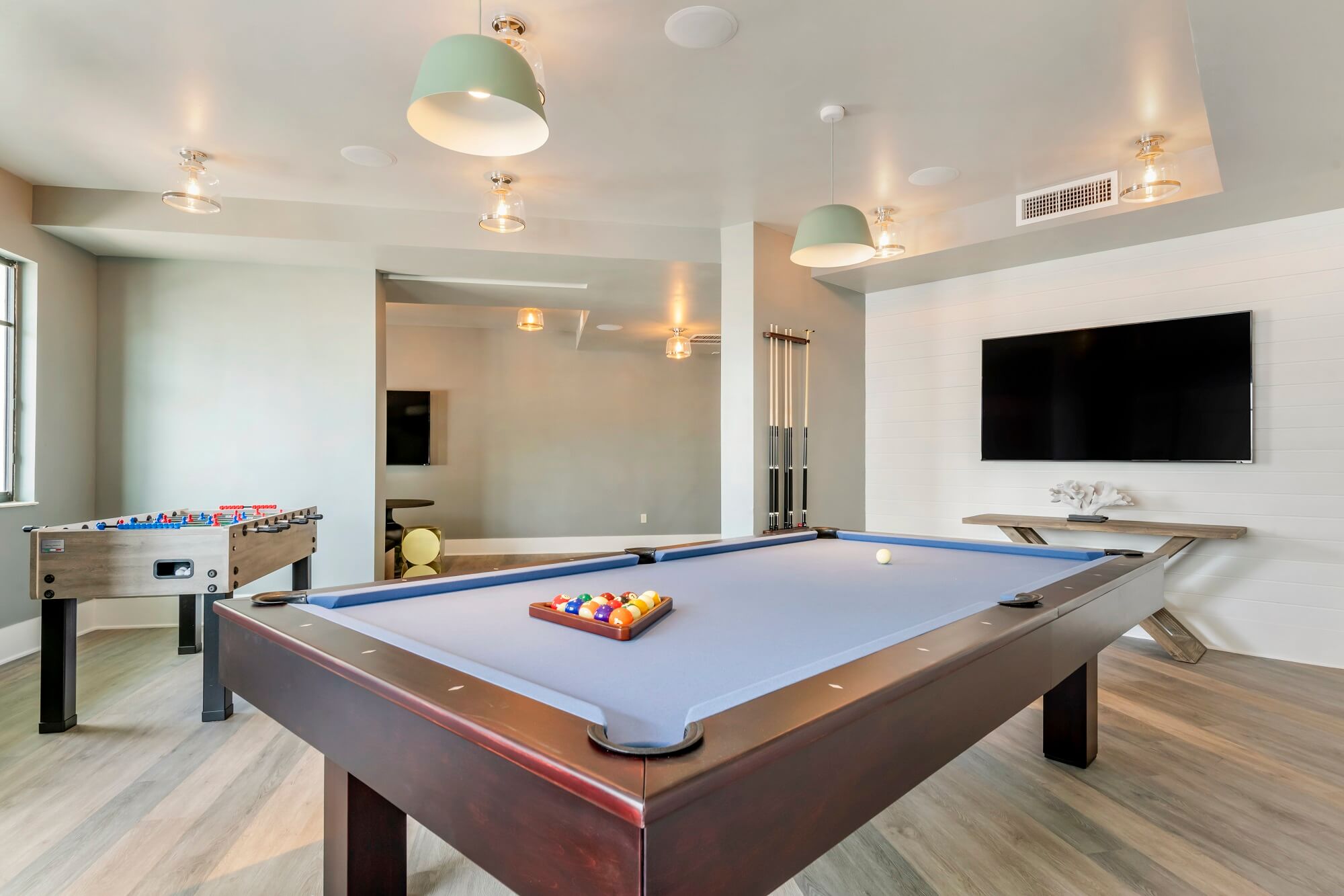 Game room at Bell Lighthouse Point, Pompano Beach, FL with pool table and foosball, resort-style coastal apartments.