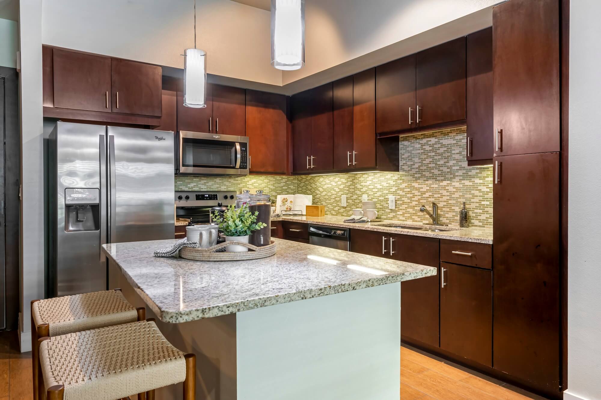 Modern kitchen in Bell Lighthouse Point, Pompano Beach, FL - granite countertops, stainless appliances, resort-style coastal living.